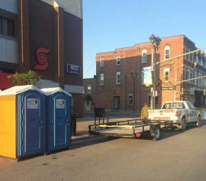 Mike Clark delivering porta-potties to a downtown event